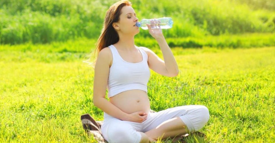 pregnant woman drinking water